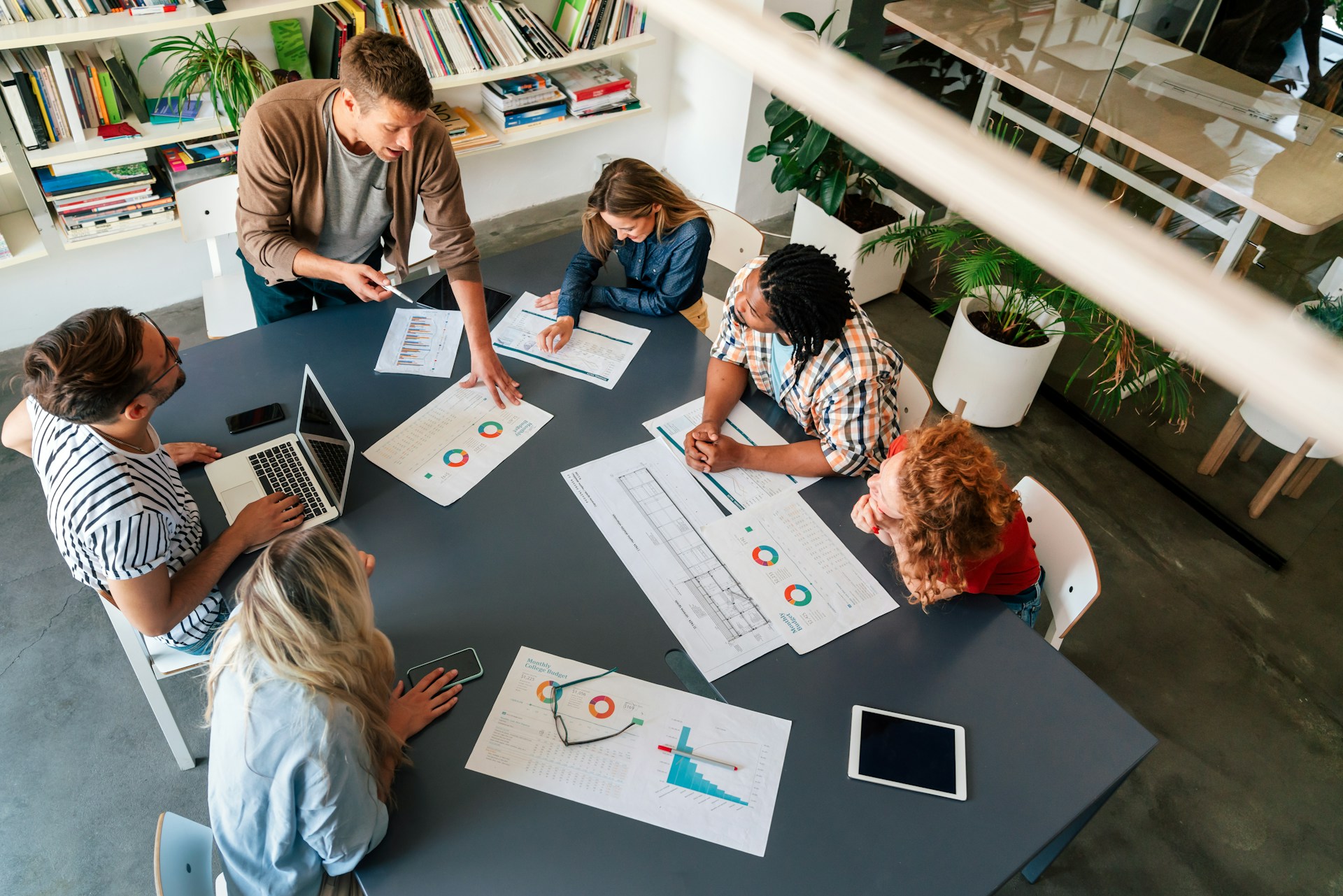 A project team reviewing plans together around a table