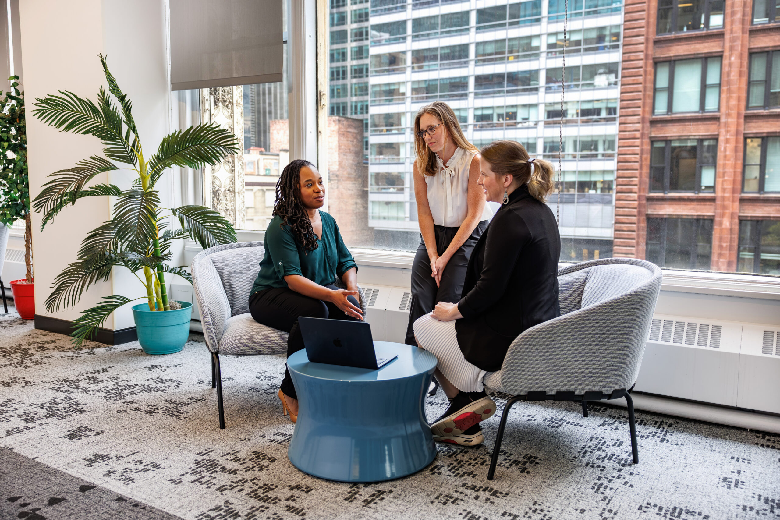 A project team reviewing plans together around a table