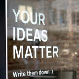 A sign reading "Your ideas matter — write them down"