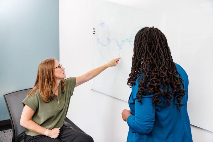 A facilitator leading a working session with a small group around a table