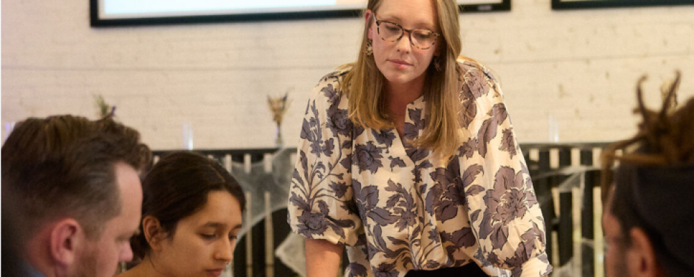A facilitator leading a discussion with a seated group
