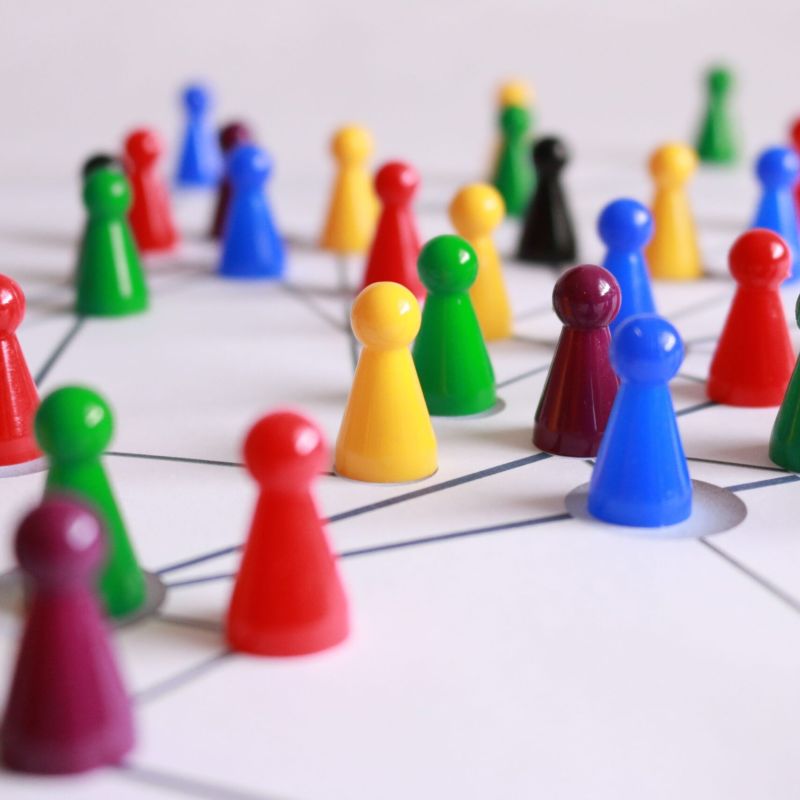 colored pegs on a white page with lines drawn connecting them